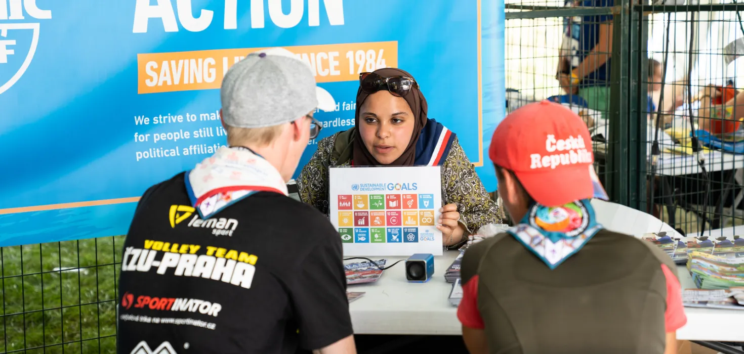 Woman showing SDGs to Scouts at the GDV of the World Scout Jamboree 2019 North America