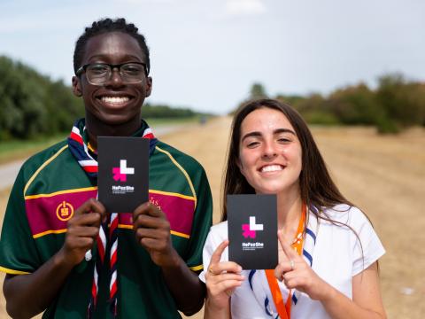 two scouts holding a heforshe campaign cards